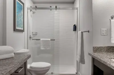 a bathroom with a glass shower with a toilet at Club Wyndham Dolphin's Cove in Anaheim