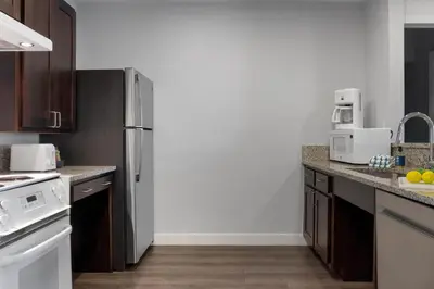 a kitchen with a stainless steel refrigerator and cabinets at Club Wyndham Dolphin's Cove in Anaheim