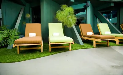 a group of chairs sitting on the grass at Hotel Current in Long Beach