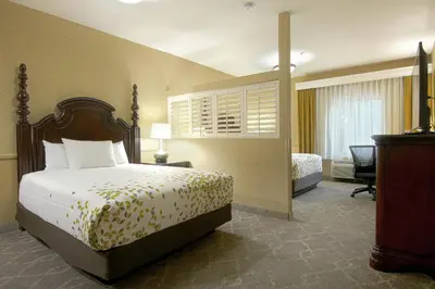 a hotel room with a bed and a desk at Azure Hotel&Suites Ontario Trademark Collection by Wyndham in Ontario
