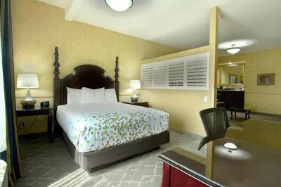 a hotel room with a bed and a desk at Azure Hotel&Suites Ontario Trademark Collection by Wyndham in Ontario