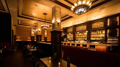 a restaurant with a bar with tables and chairs at Hollywood Historic Hotel in Los Angeles