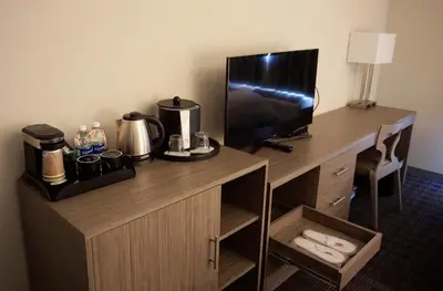 a desk in a hotel room with a television on it at Hartford Hotel Best Western Signature Collection in Rosemead