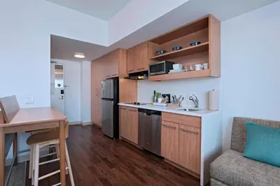 a kitchen with wooden cabinets and a counter top at Element Palmdale in Palmdale