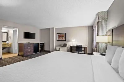 a hotel room with a large bed and a desk at Best Western Los Alamitos Inn & Suites in Los Alamitos
