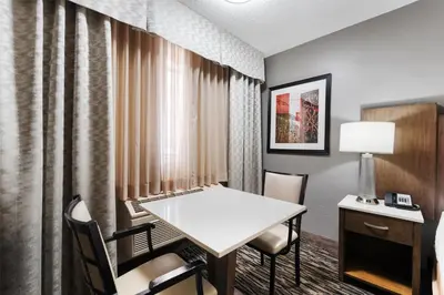 a room with a table and chairs and a desk at Best Western Los Alamitos Inn & Suites in Los Alamitos