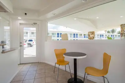 a bar with two chairs and a table in a room at Motel 6-San Bernardino, CA - Downtown in San Bernardino
