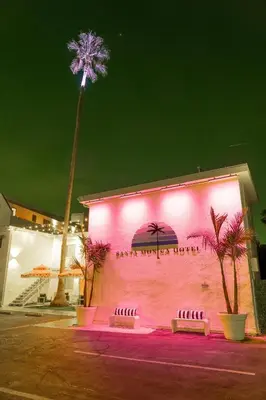 a pink building with a palm tree behind it at Santa Monica Hotel in Los Angeles