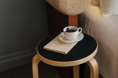 a cup of coffee on a table next to a bed at Palihotel Westwood Village - West Beverly Hills in Los Angeles