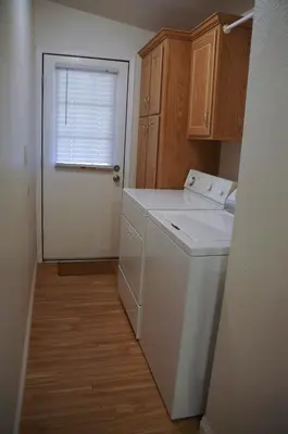 a kitchen with a washer and dryer and a window at Country Club Chalet in Big Bear City
