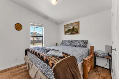 a bedroom with a bed and a window at Country Club Chalet in Big Bear City