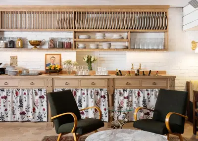 a kitchen with a counter with chairs and a table at Palihouse West Hollywood at Beverly Hills in Los Angeles