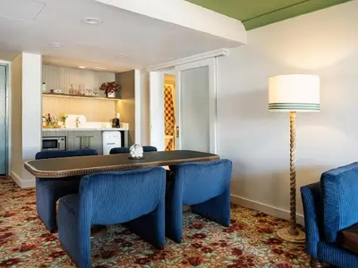 a dining room with a table and blue chairs at Palihouse West Hollywood at Beverly Hills in Los Angeles