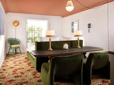 a bedroom with a bed and a table and chairs at Palihouse West Hollywood at Beverly Hills in Los Angeles