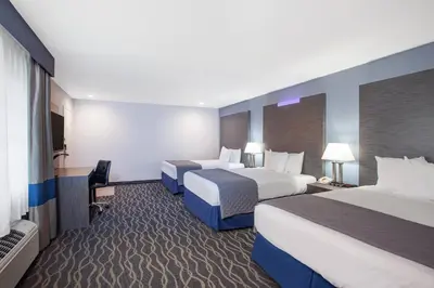a hotel room with two beds and a television at Travelodge Inn & Suites by Wyndham Anaheim on Disneyland Dr in Anaheim