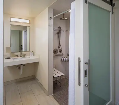 a bathroom with a sink and a shower at Ocean View Hotel in Los Angeles