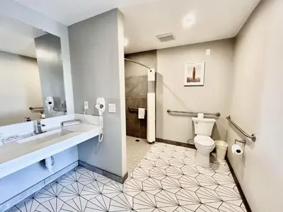 a bathroom with a sink and a toilet at Alamo Inn and Suites - Convention Center in Anaheim