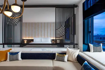 a living room with a couch and a bed at W Hollywood in Los Angeles