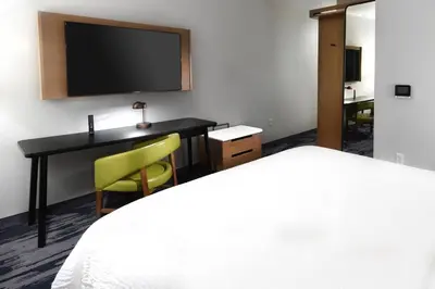 a hotel room with a bed and a desk with a television at Fairfield Inn & Suites Ontario Rancho Cucamonga in Rancho Cucamonga