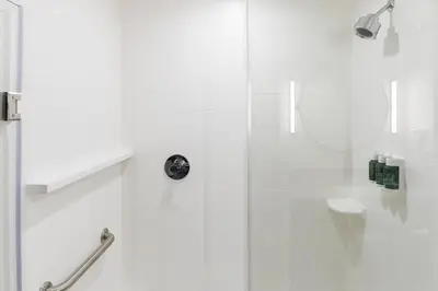 a white bathroom with a shower and a toilet at Fairfield Inn & Suites Ontario Rancho Cucamonga in Rancho Cucamonga