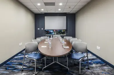 a conference room with a large wooden table and chairs at Fairfield Inn & Suites Ontario Rancho Cucamonga in Rancho Cucamonga