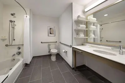 a bathroom with a sink and a tub and a toilet at Hampton Inn Long Beach Airport, Ca in Long Beach