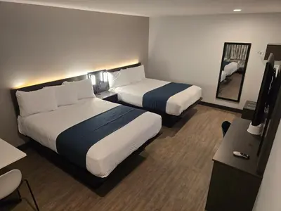 a hotel room with two beds and a desk at Motel 6 Los Angeles, CA - Downtown in Los Angeles