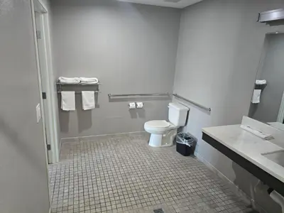 a bathroom with a toilet and a sink at Motel 6 Los Angeles, CA - Downtown in Los Angeles