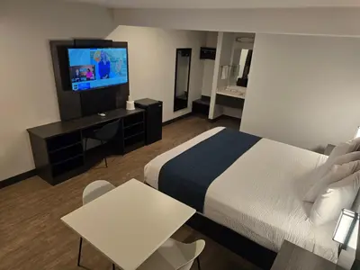a hotel room with a bed and a flat screen tv at Motel 6 Los Angeles, CA - Downtown in Los Angeles