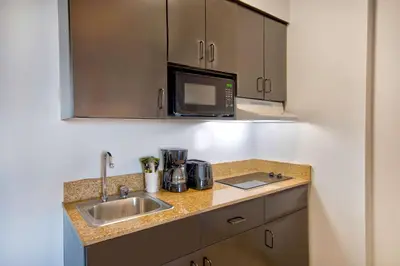 a kitchen with a sink and a microwave at Studio 6-Bakersfield, CA in Bakersfield