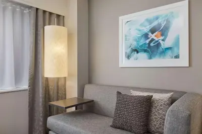 a living room with a couch and a lamp at DoubleTree by Hilton Los Angeles Norwalk in Norwalk