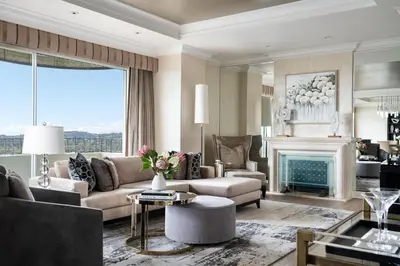 a living room with a couch and a fireplace at Four Seasons Hotel Los Angeles at Beverly Hills in Los Angeles