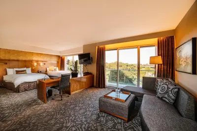 a hotel room with a bed and a desk at Miyako Hybrid Hotel Torrance in Torrance