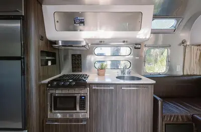 an rv kitchen with a sink and a stove at Caravan Outpost in Ojai