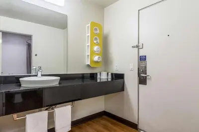 a bathroom with a sink and a mirror at Motel 6-Redlands, CA in Redlands