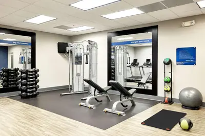 a gym with treadmills and chairs in a room at Hampton Inn & Suites Ridgecrest in Ridgecrest