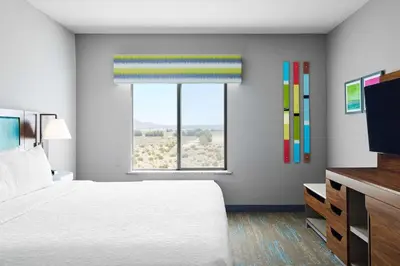 a bedroom with a large bed and a window at Hampton Inn & Suites Ridgecrest in Ridgecrest