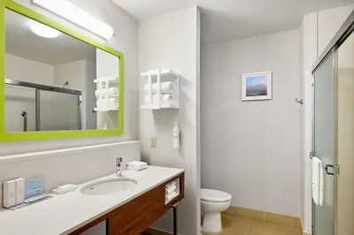 a bathroom with a sink and a toilet and a mirror at Hampton Inn & Suites Ridgecrest in Ridgecrest