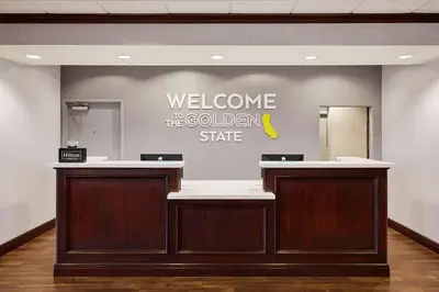 a welcome to the golden state sign on a wall at Hampton Inn & Suites Ridgecrest in Ridgecrest