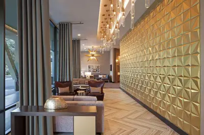 a lobby of a hotel with a brick wall at H Hotel Los Angeles, Curio Collection By Hilton in Los Angeles