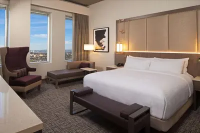 a hotel room with a bed and a chair at H Hotel Los Angeles, Curio Collection By Hilton in Los Angeles