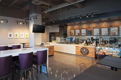 a restaurant with purple chairs and a counter at Homewood Suites By Hilton Los Angeles International Airport in Los Angeles