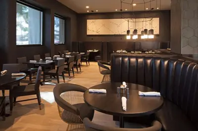 a restaurant with tables and chairs and a bar at Homewood Suites By Hilton Los Angeles International Airport in Los Angeles