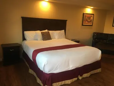 a bedroom with a large bed in a hotel room at Budget Lodge San Bernardino in San Bernardino