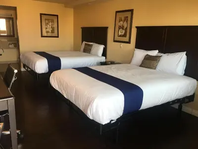 a couple of beds in a hotel room at Budget Lodge San Bernardino in San Bernardino