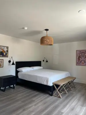 a bedroom with a bed and a bench in it at Anaheim Maingate Inn in Anaheim