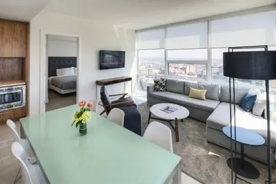 a living room with a couch and a table at Luxurious Highrise 2b 2b Apartment Heart Of Downtown LA in Los Angeles