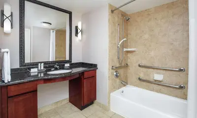 a bathroom with a tub and a sink and a shower at Homewood Suites by Hilton Agoura Hills in Agoura Hills