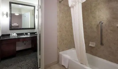 a bathroom with a tub and a sink and a shower at Homewood Suites by Hilton Agoura Hills in Agoura Hills
