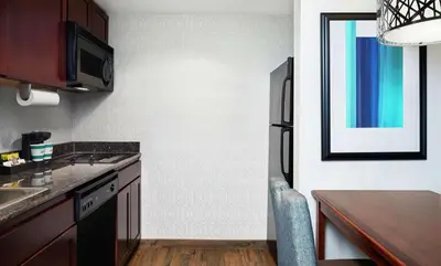 a kitchen with a sink and a table in it at Homewood Suites by Hilton Agoura Hills in Agoura Hills